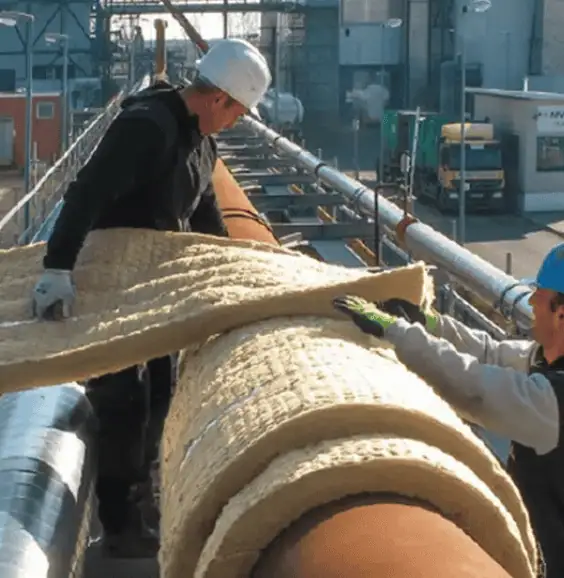Industrial Pipe Insulation Installation Workers installing stone wool insulation on industrial pipes